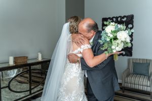Touching embrace shared during an intimate wedding day moment.