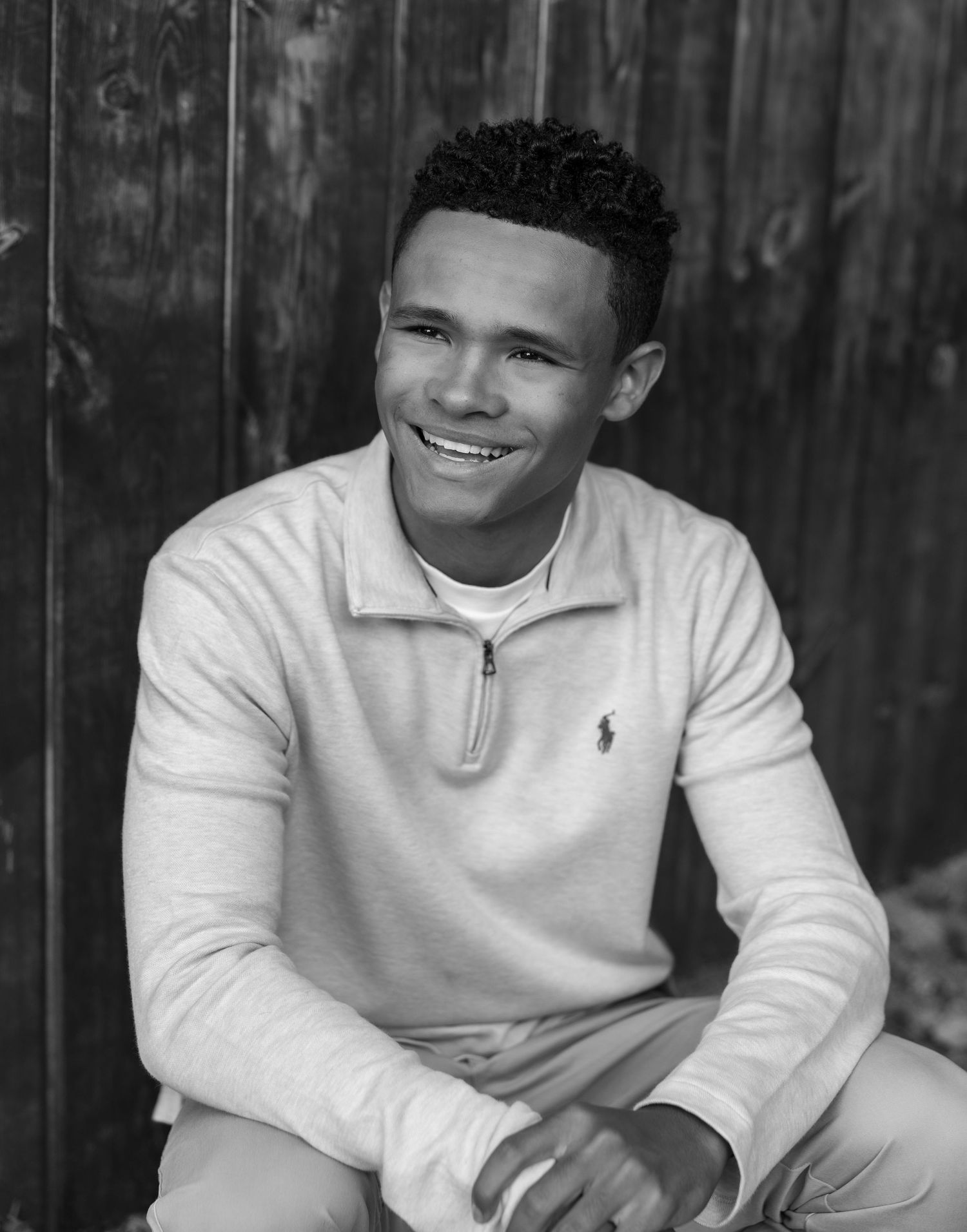 A series of black and white portraits showing a young person in a white polo shirt with various expressions.