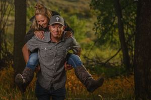 A man giving a woman a piggyback ride while they both laugh