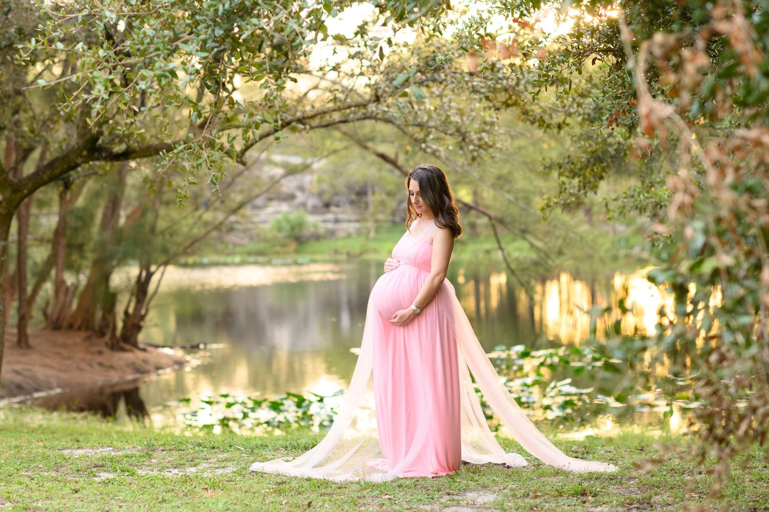 mom during golden hour holding baby bump