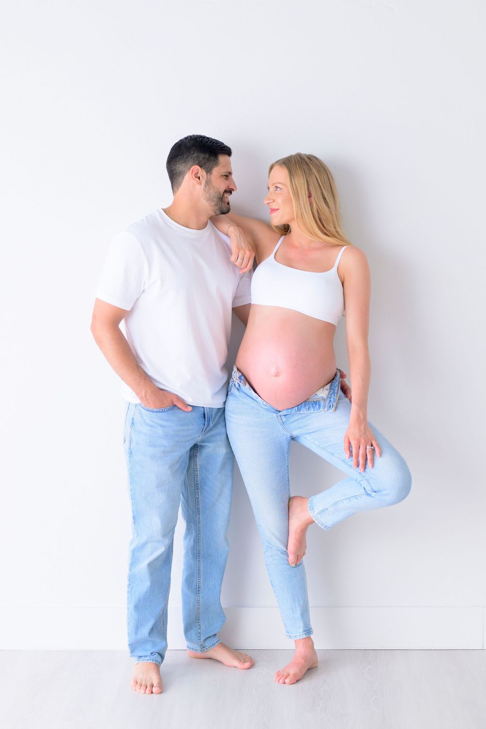 couple against white wall