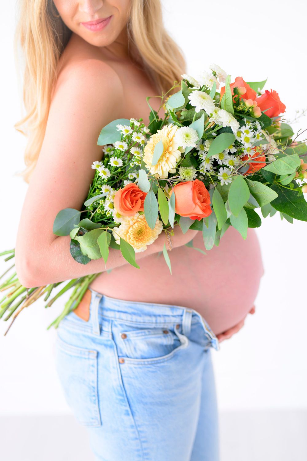 close up of mom's baby bump with flowers
