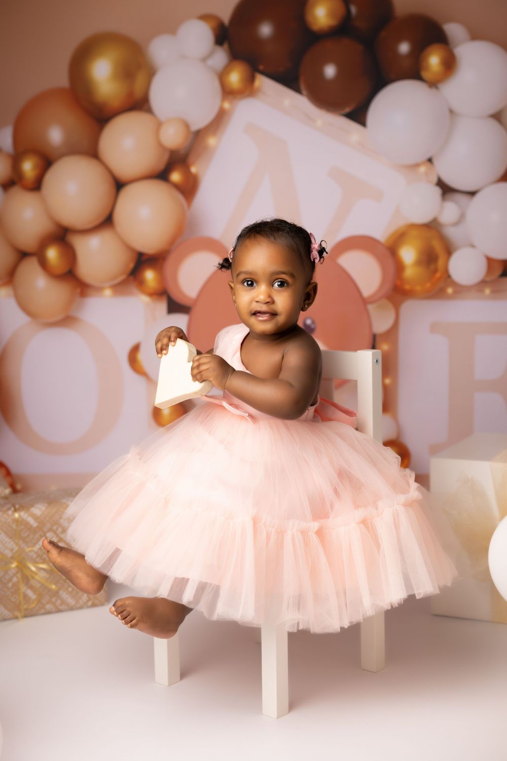 girl child sitting on a chair  first birthday portrait photo