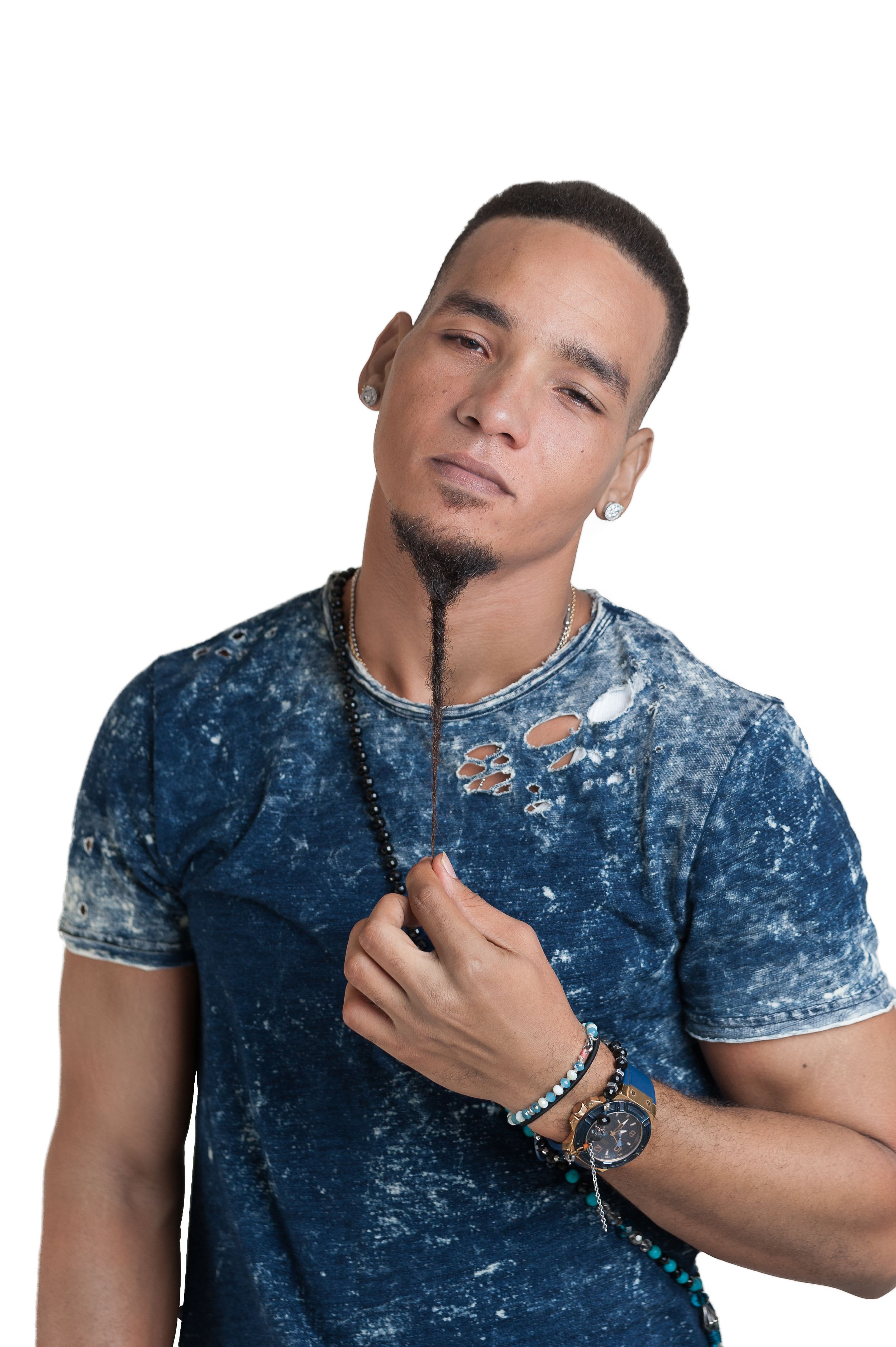 Person in blue acid wash t-shirt with jewelry poses against white background.