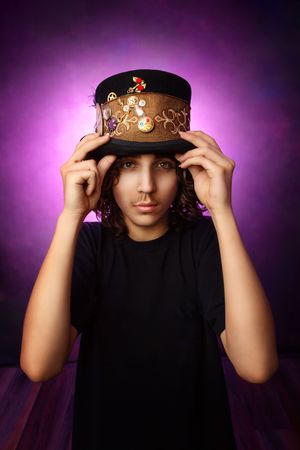 A steampunk-style top hat adorned with gears and decorative elements against a vibrant purple background.