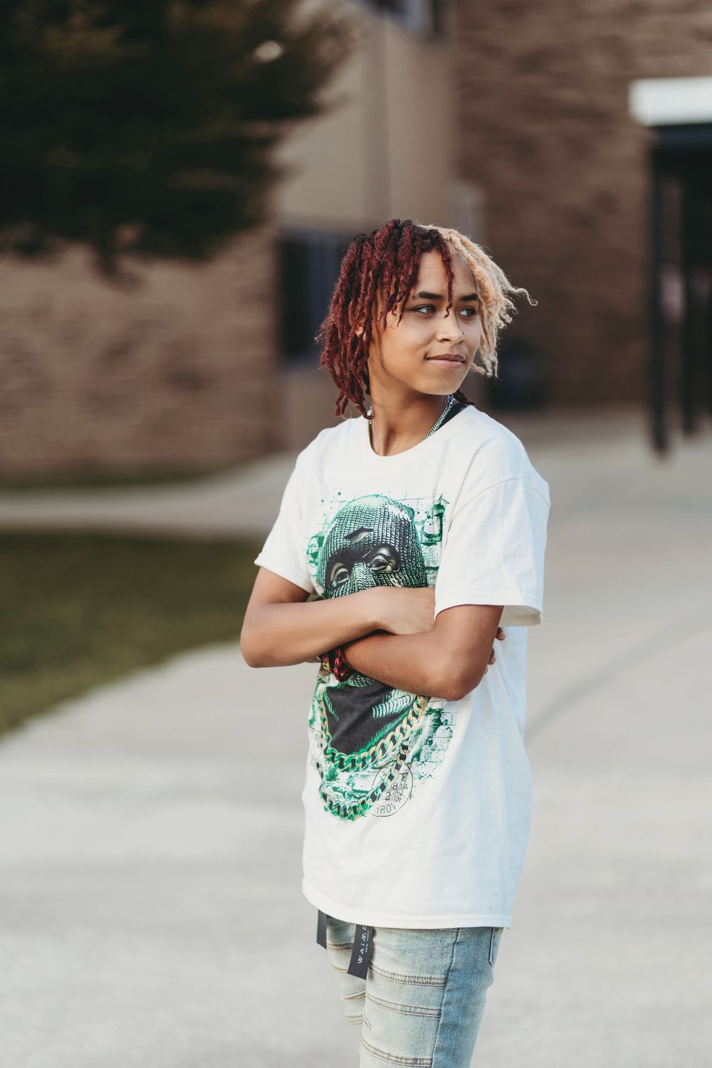 A person in a white t-shirt and light jeans poses playfully outdoors in a series of candid shots.