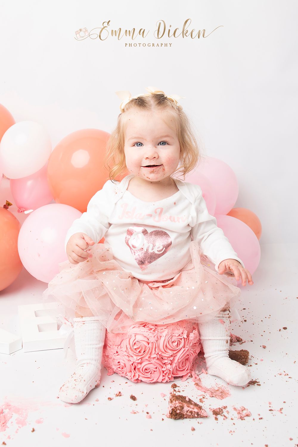 baby sitting on cake in Selby cake smash
