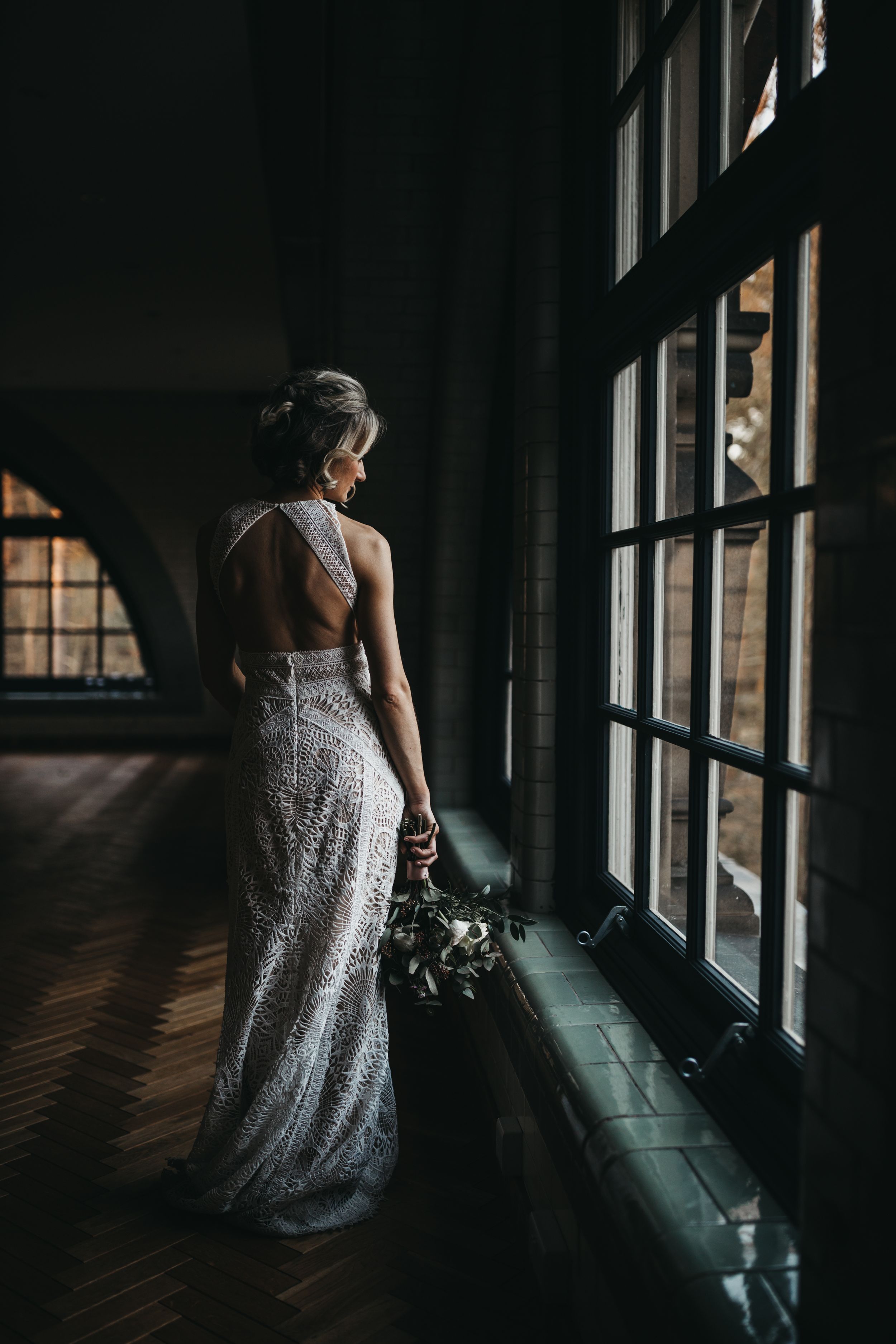 bride in wedding dress tin window light at the Pumping House Ollerton