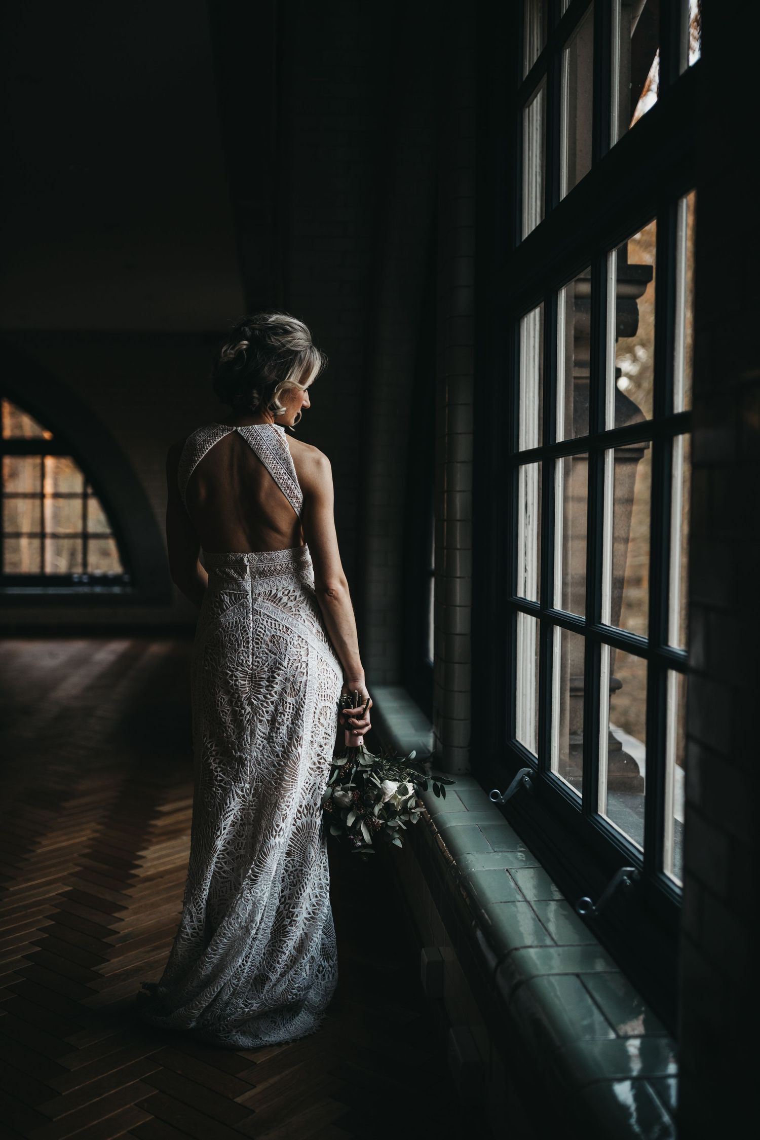 bride in wedding dress tin window light at the Pumping House Ollerton