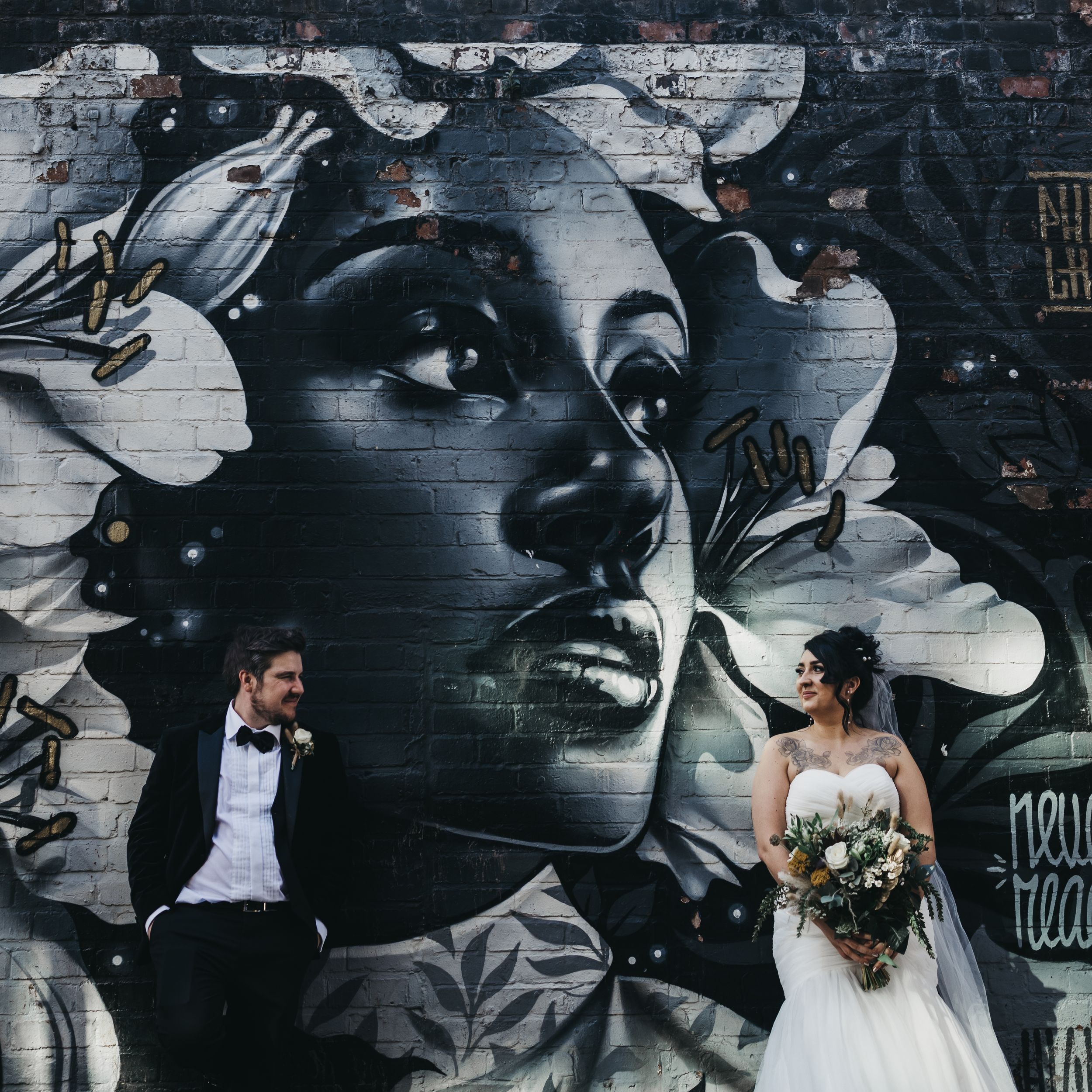 City wedding with couple stood n front of graffiti Birmingham