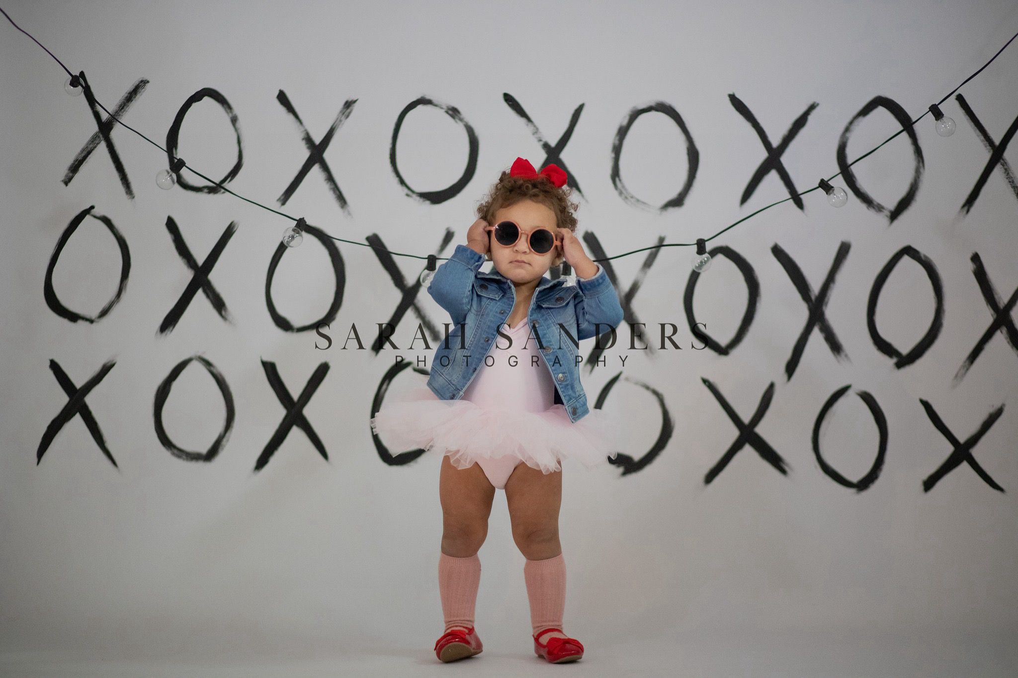 Toddler in valentines day studio XO backdrop