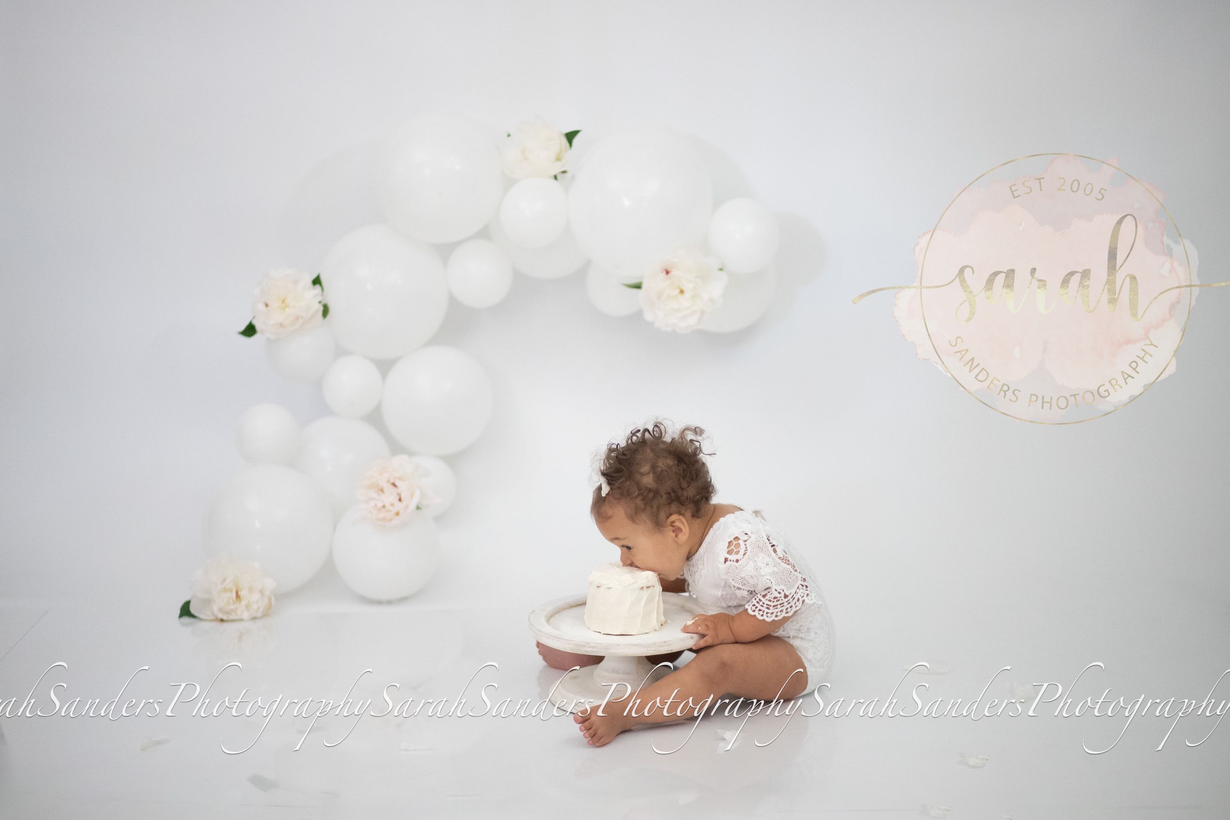 Baby eating cake at her cake smash