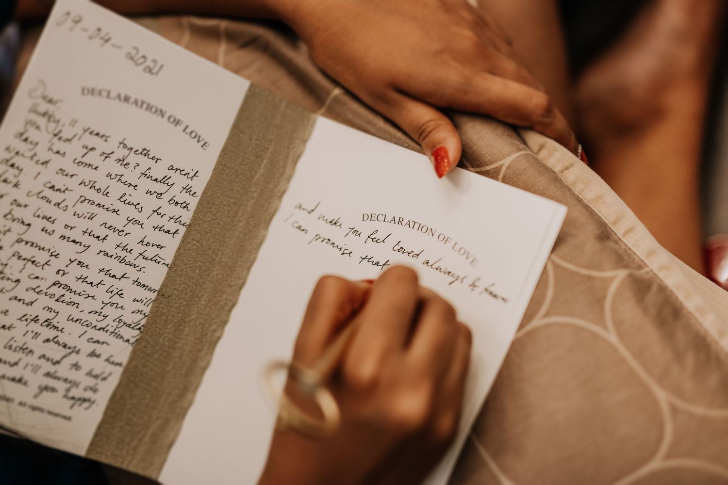 Close-up of handwritten notes in guestbook during celebration.