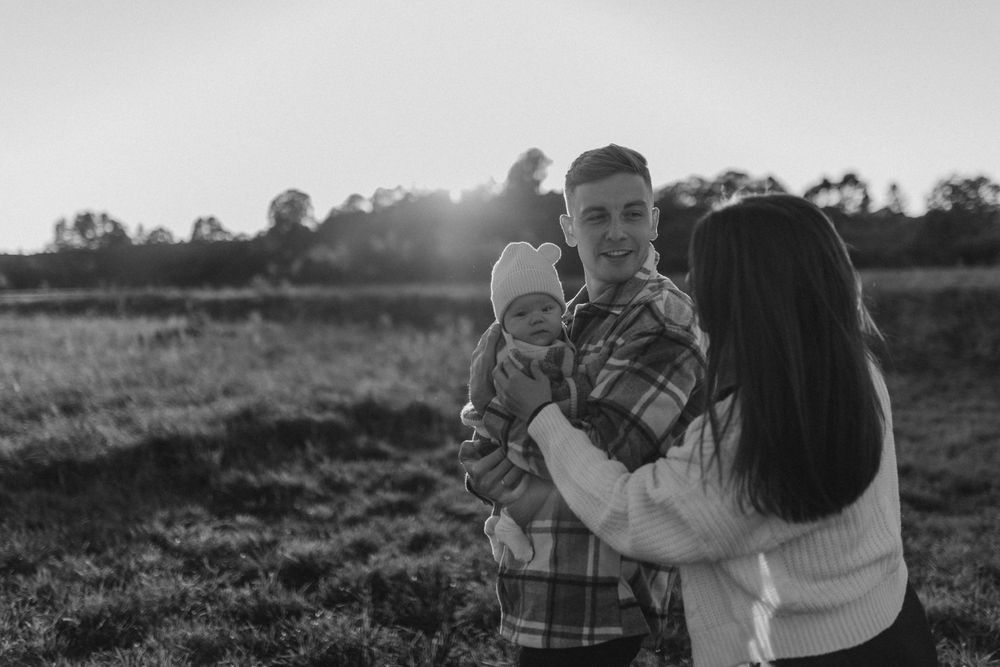 Black and white image of family moment in outdoor setting.