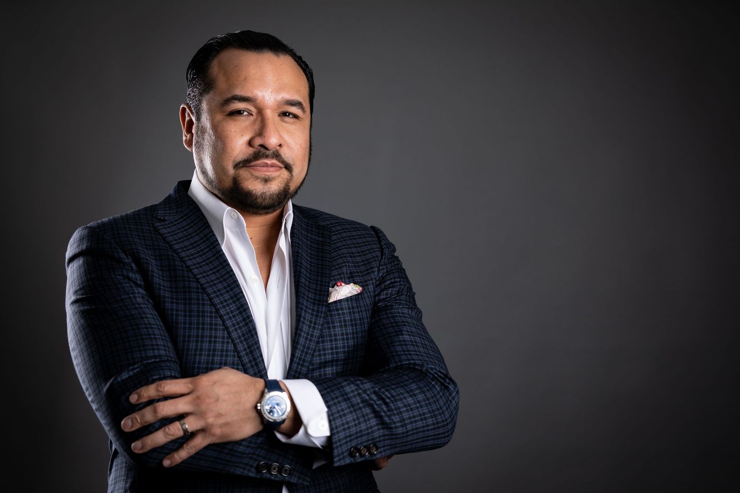 Professional headshot series against dark background showing confident poses.