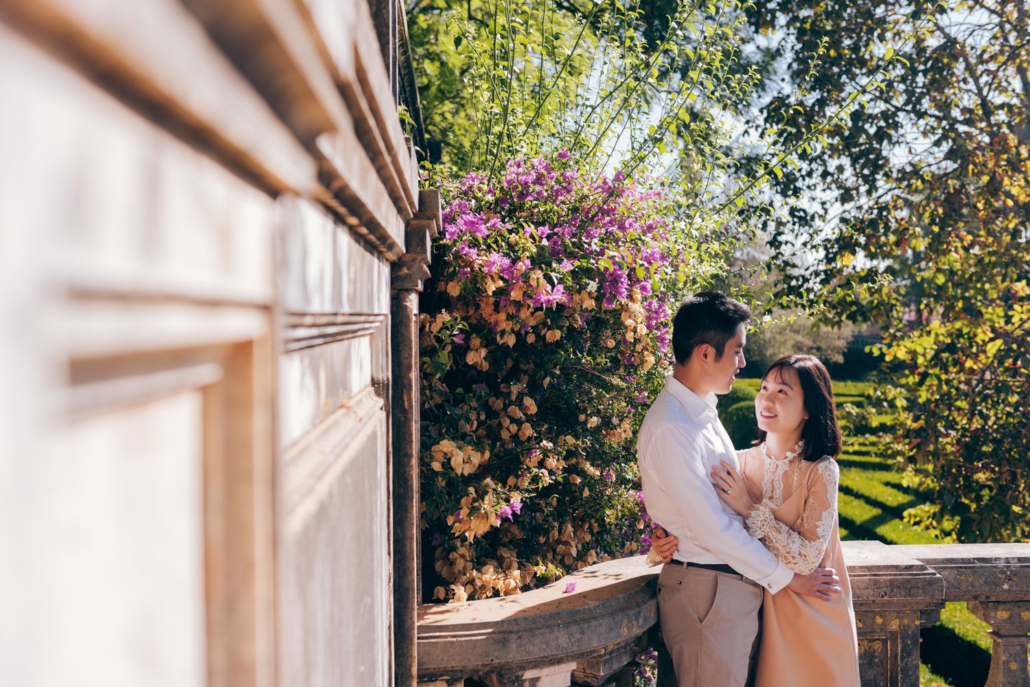 Couple hugging each other in a flowery garden