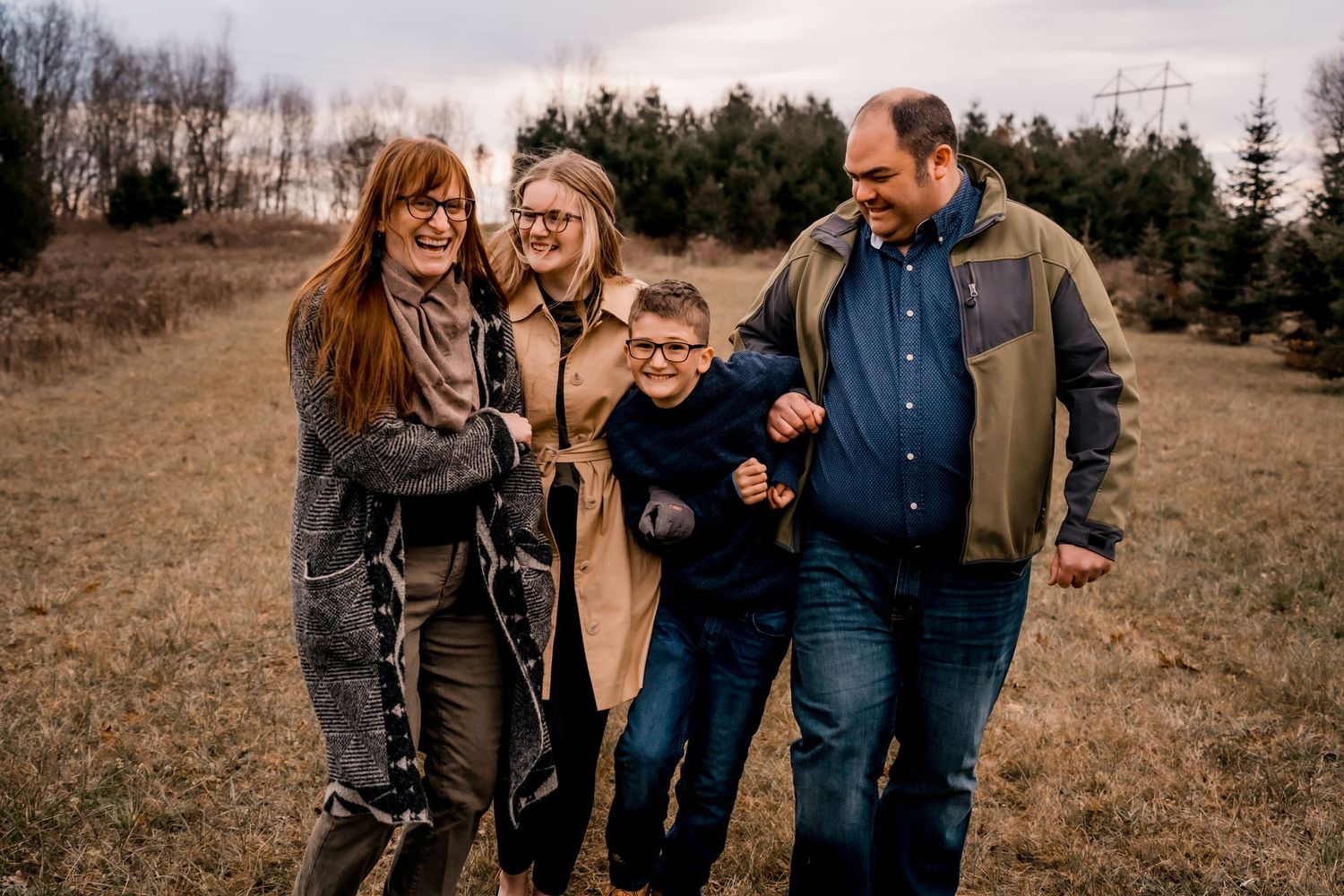 A group walking together and laughing on an autumn hillside.
