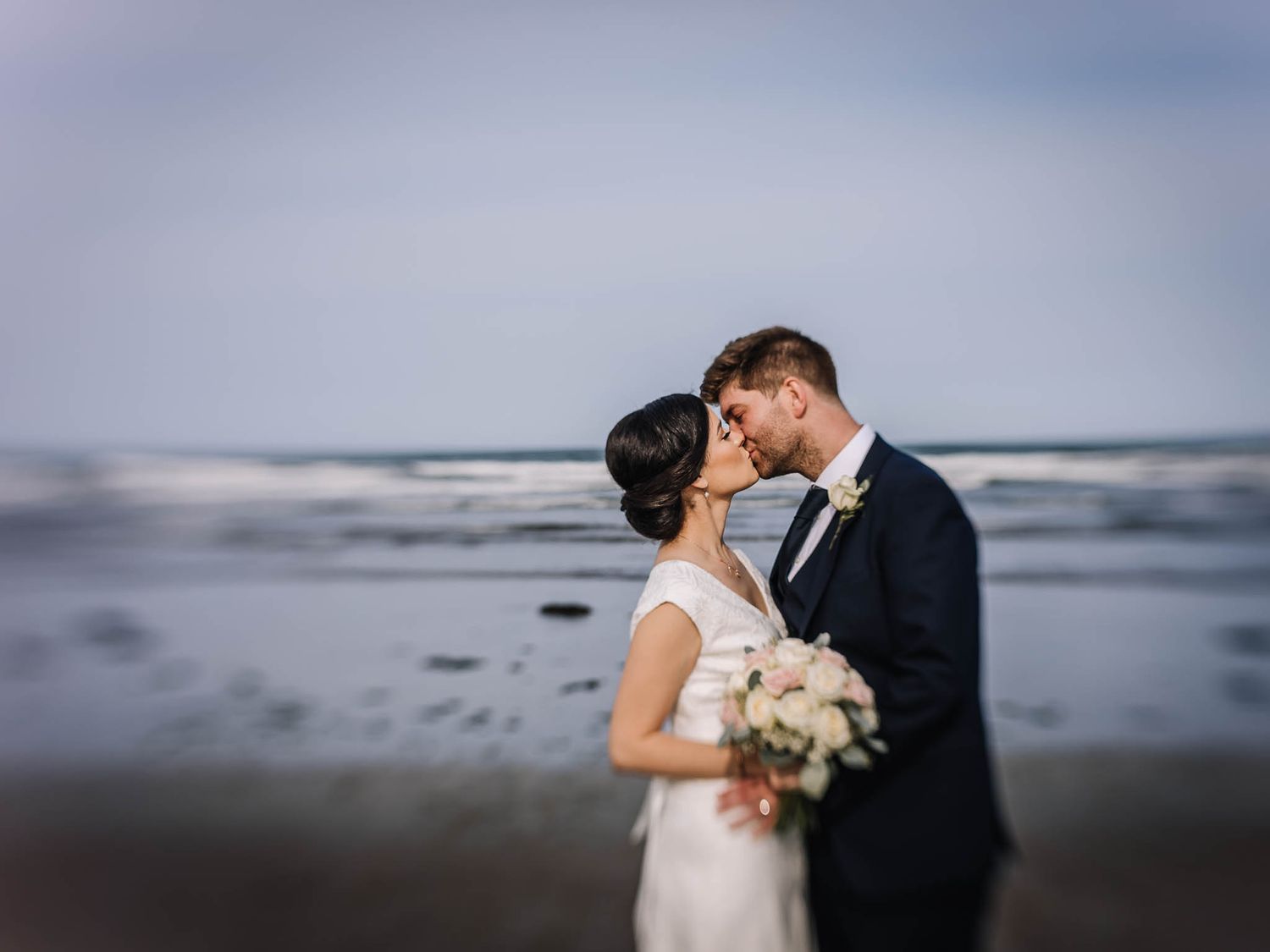 Bride and groom romantic beachscape portrait
