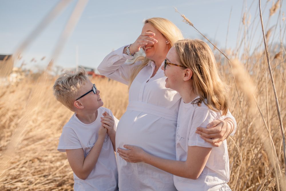 Candid laughter shared amongst tall grass during golden hour.