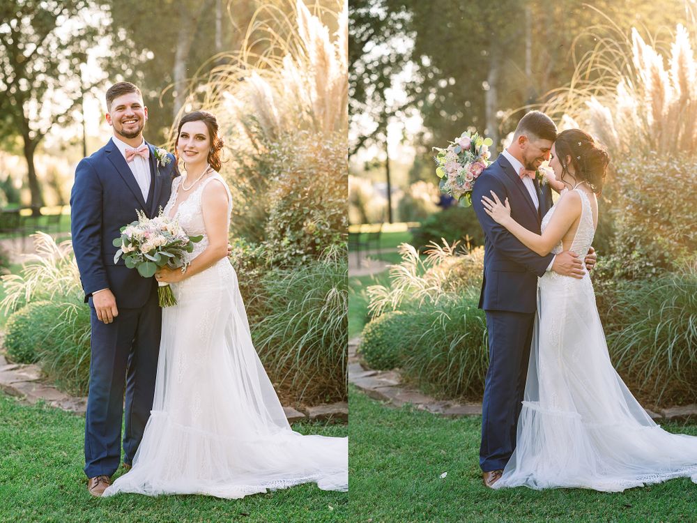 Wedding couple poses against ornamental grasses at sunset in a garden setting.