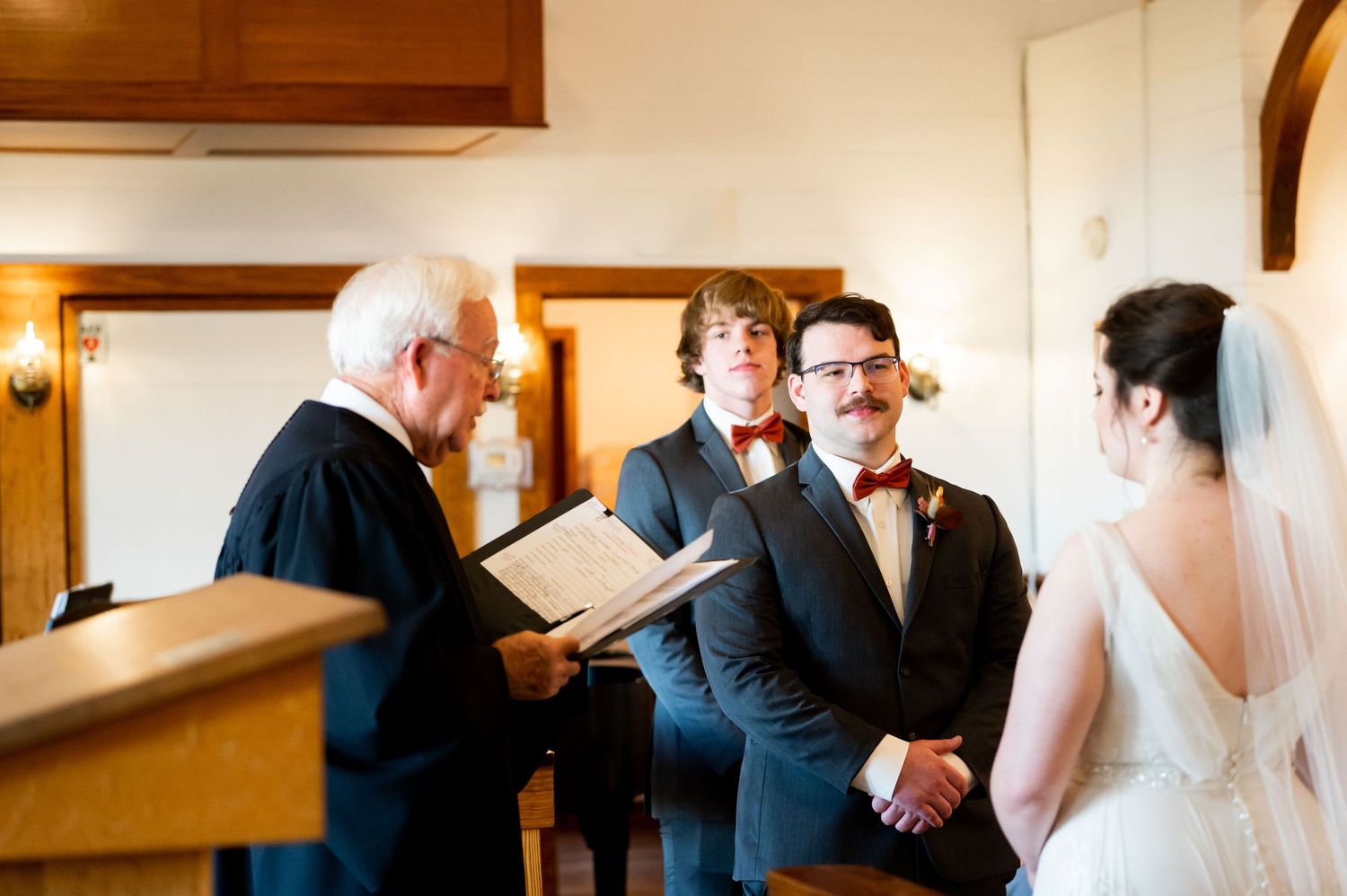 Intimate wedding ceremony moment captured in a traditional chapel setting.
