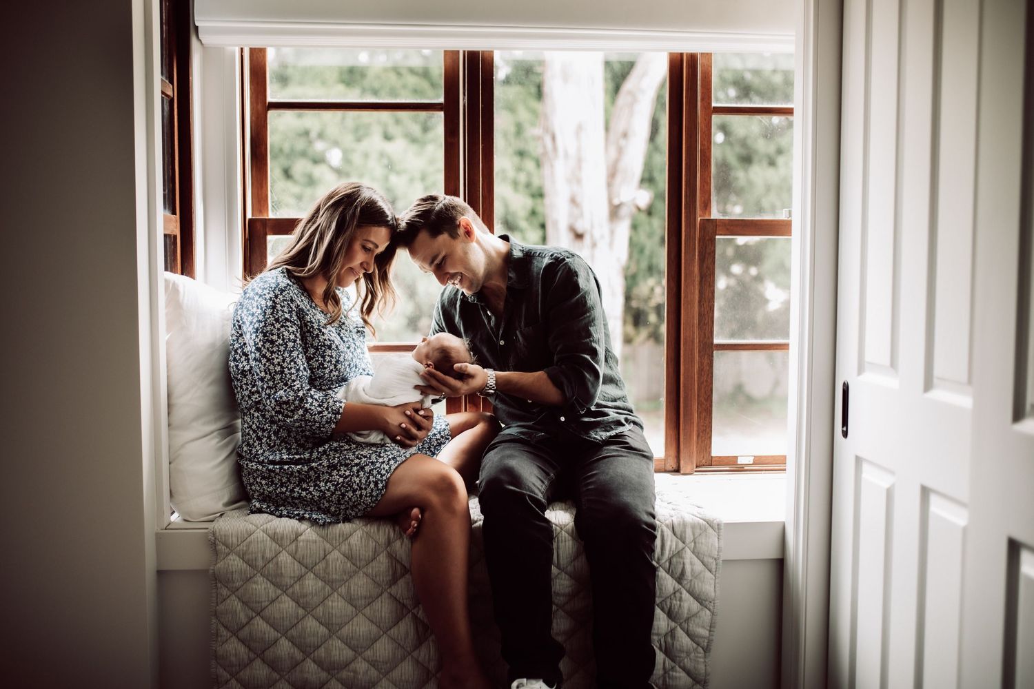 Family enjoying intimate moments while looking through a window of their home.