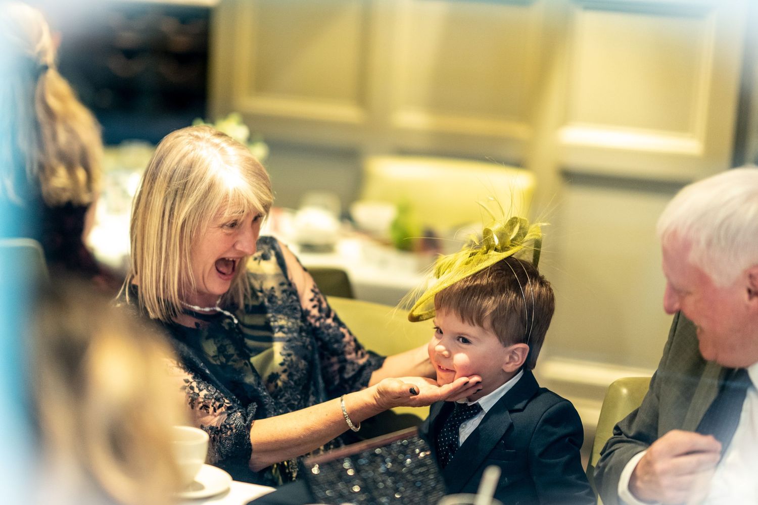 little boy wears a fascinator wedding hat during a gay wedding at chiswell street dining rooms
