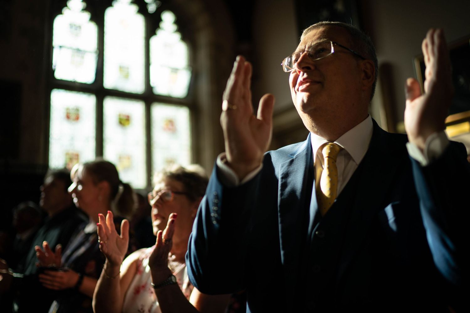 wedding guests clap during a gay wedding ceremony at the museum of the order of st John