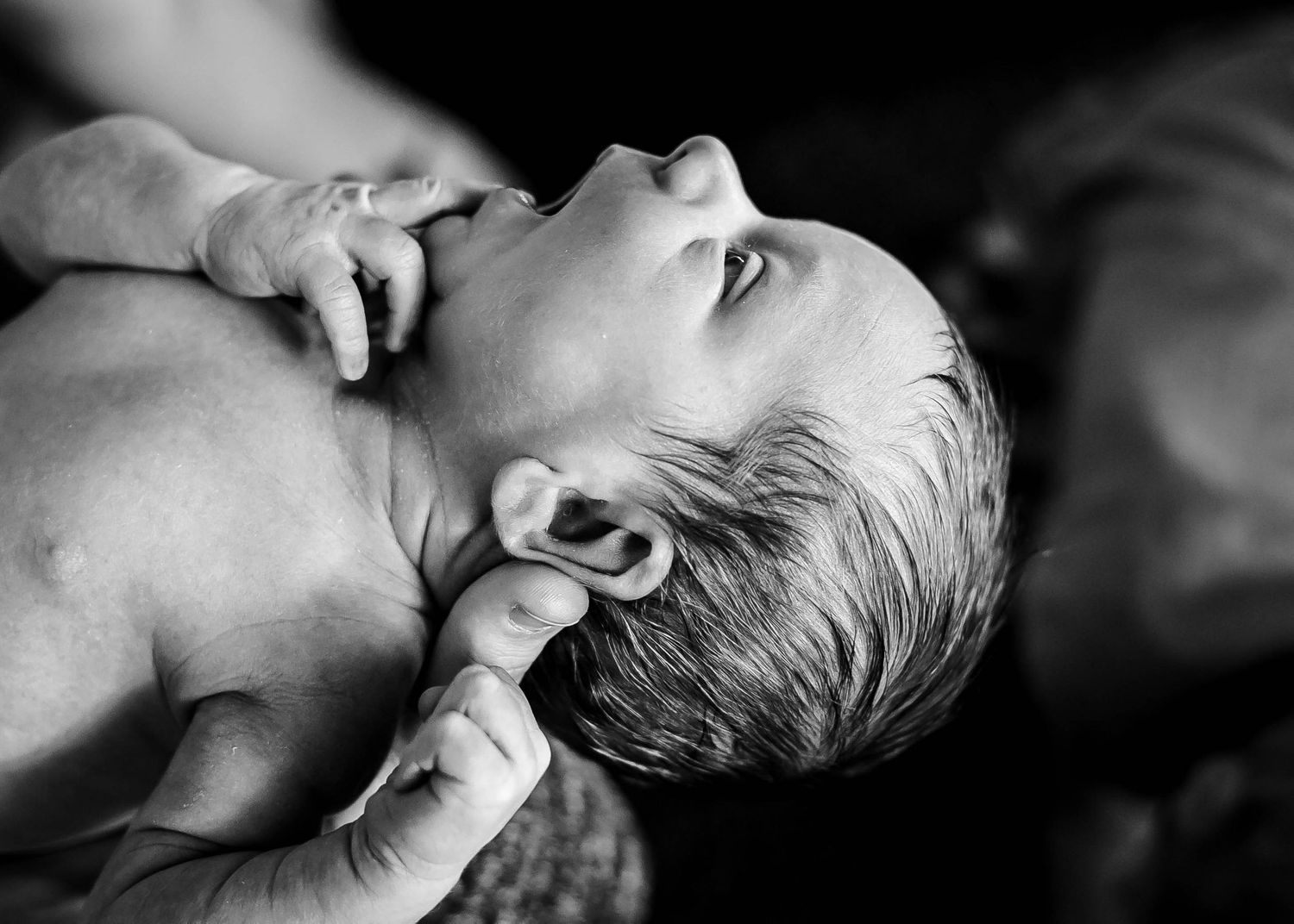 Newborn baby boy held by his mother during his fresh48 session in their home in Sioux City, IA.