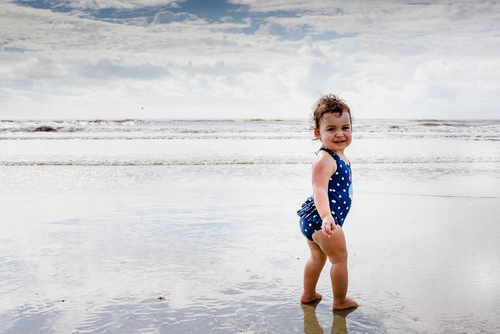 toddler in waves