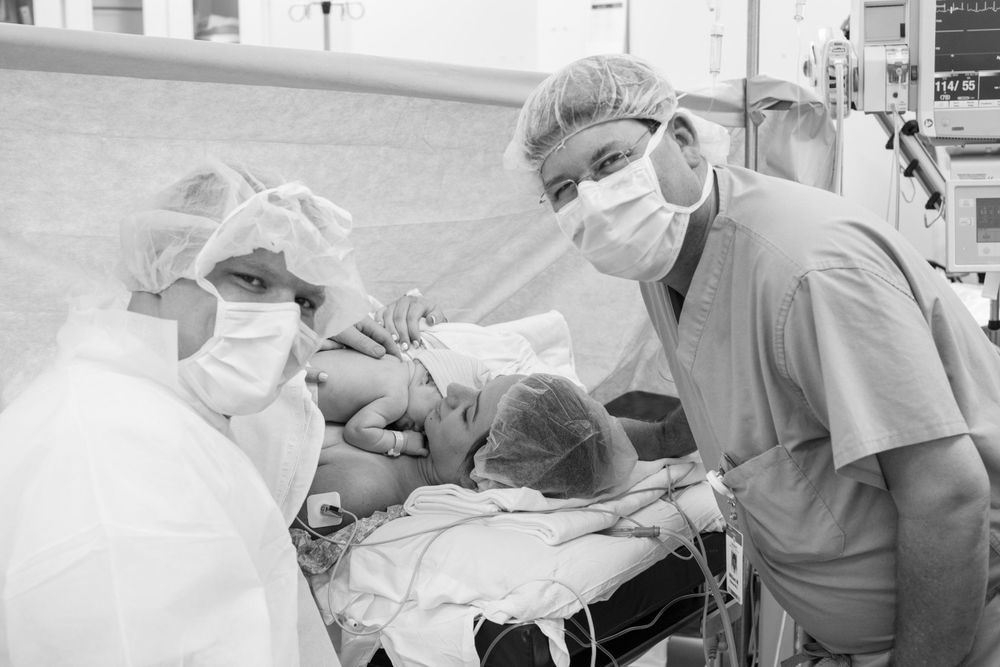 Medical staff attend to patient during hospital procedure.