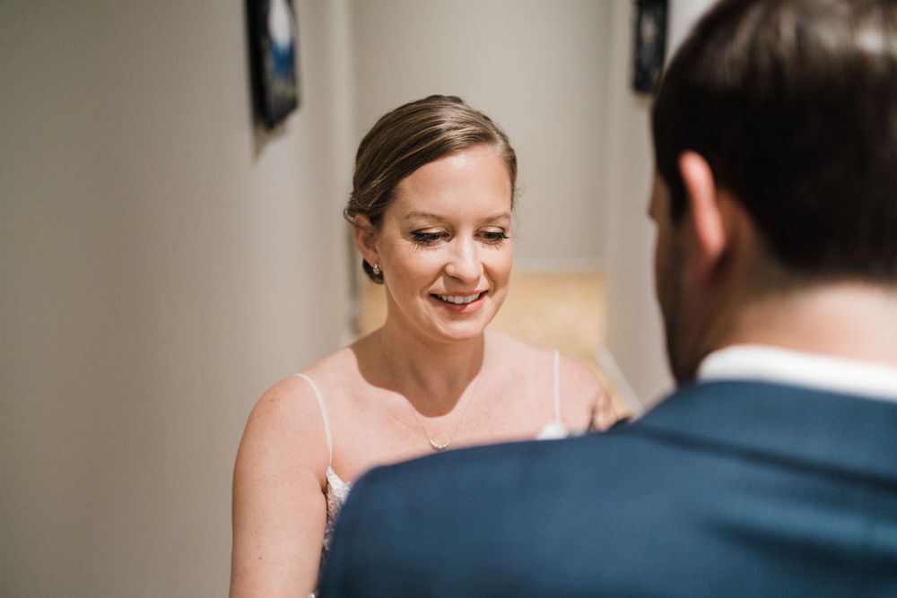 Candid moment captured during wedding first look.