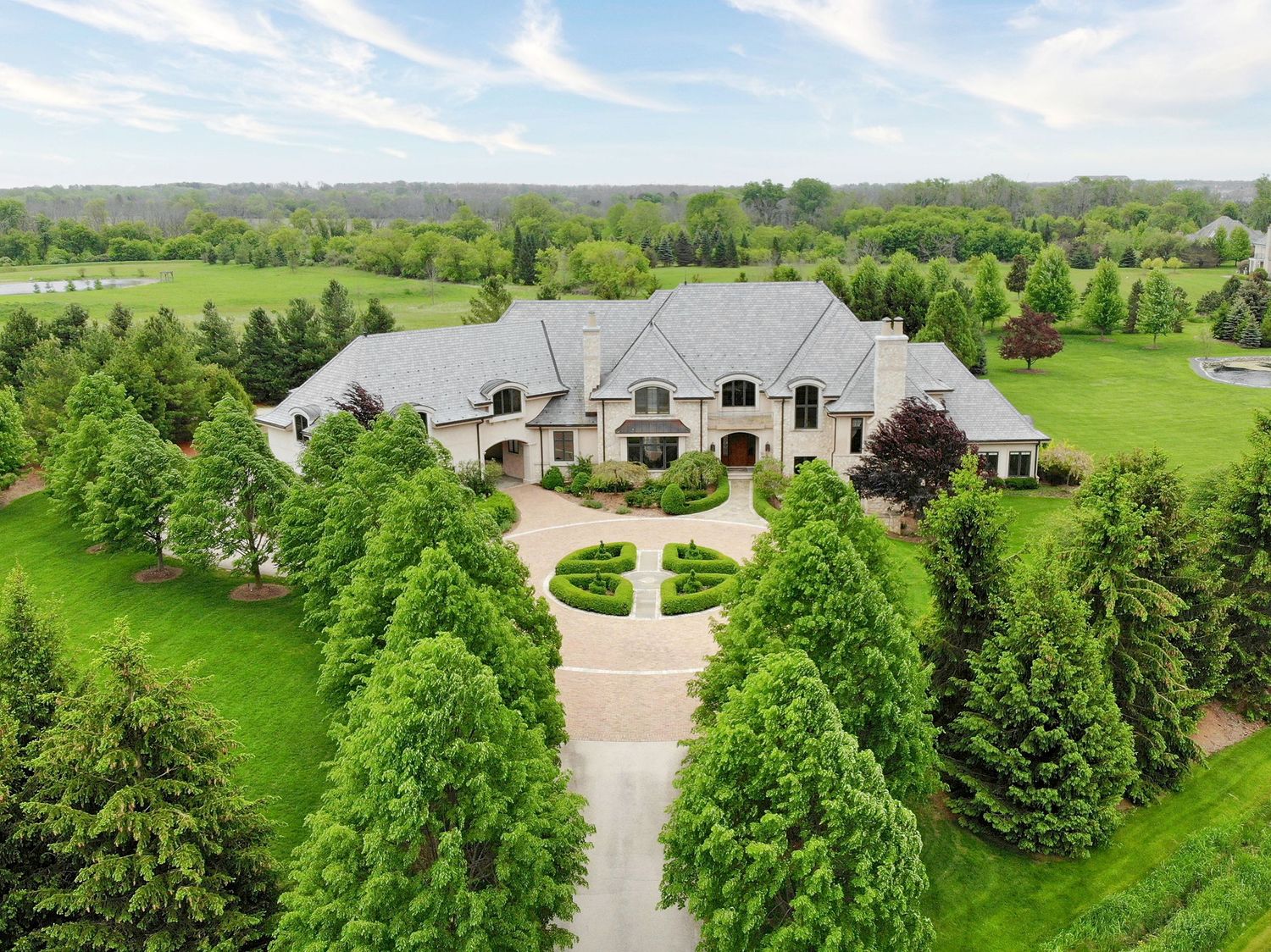 Aerial drone photo of a large estate home surrounded by trees, Milwaukee Wisconsin