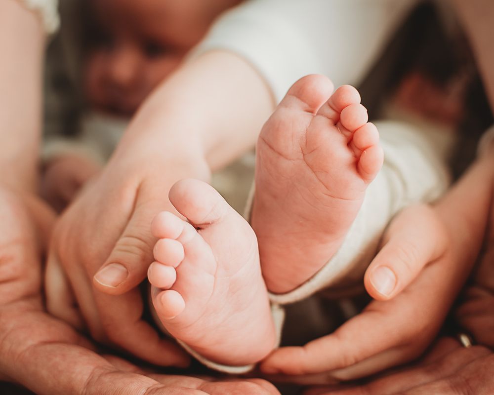 Infant Feet in family hands