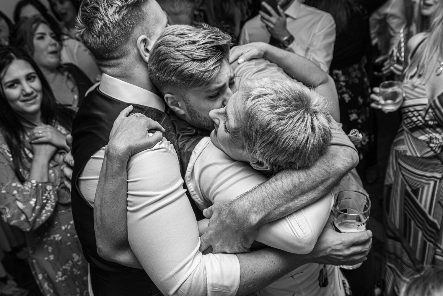Groom and groom hugging on the dance floor.