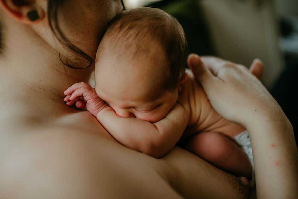 squishy newborn on mother's chest in-home newborn photography session portland oregon