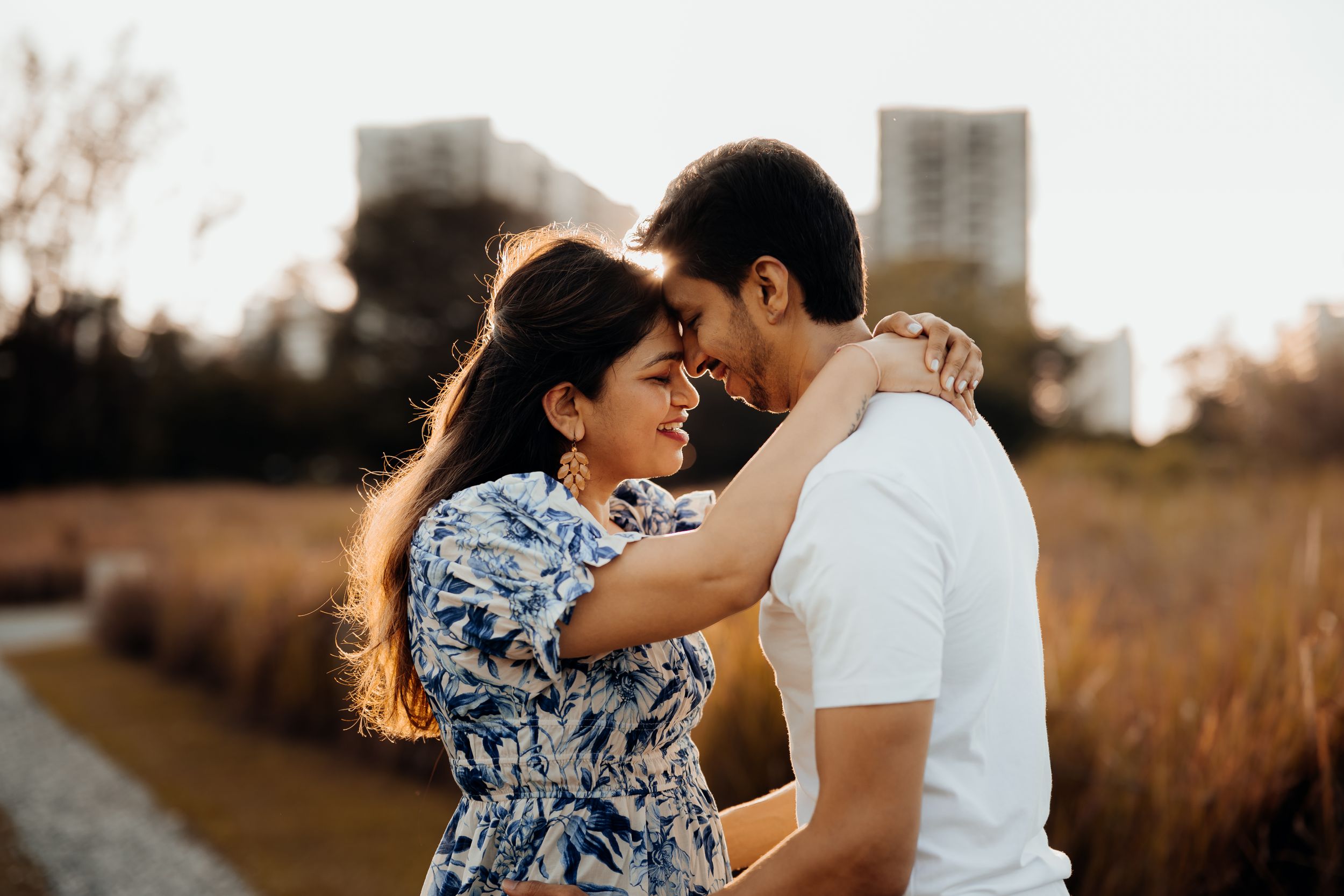 Couple kissing with sunsetting at the back