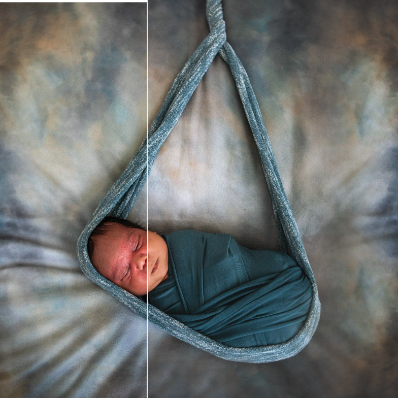 Newborn sleeping peacefully in grey hanging swing against textured backdrop.