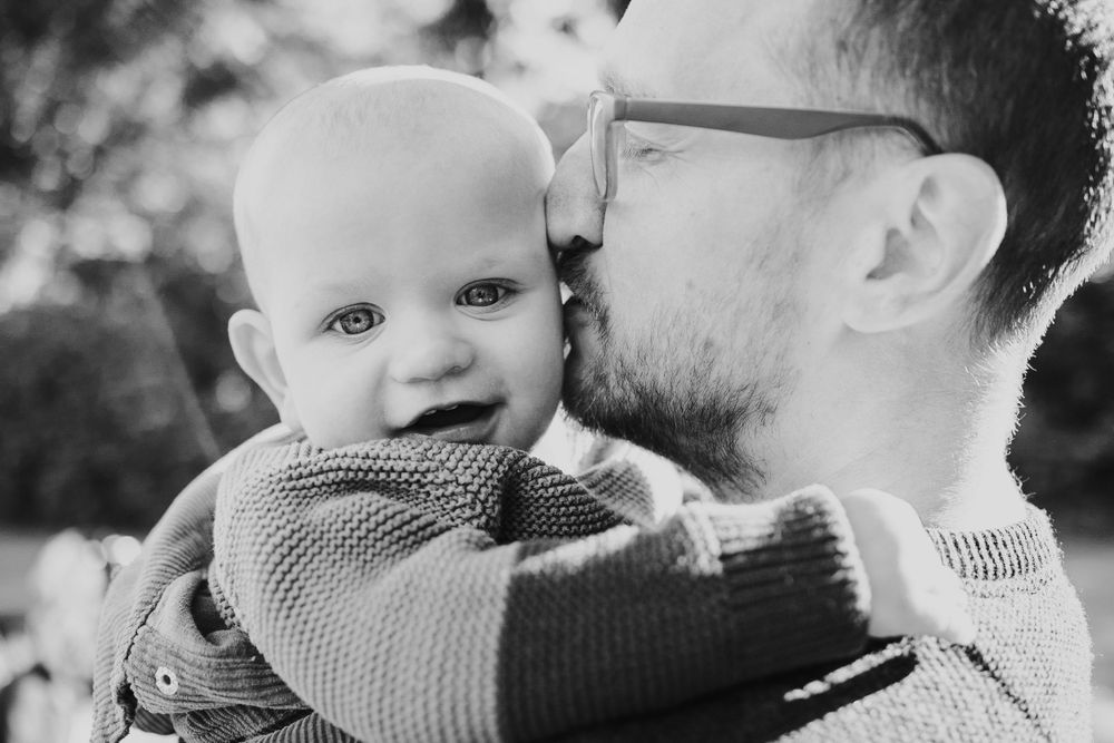 Black and white intimate portrait of tender moment between two people.