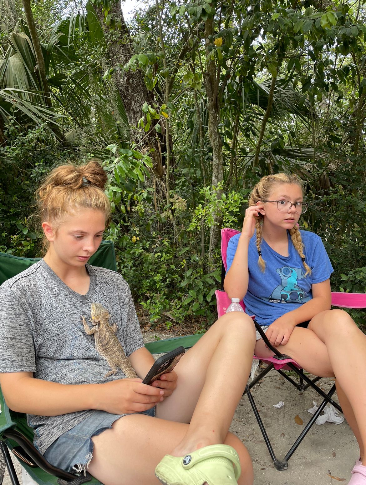 Alysah and Kayleigh relaxing by the campfire circle