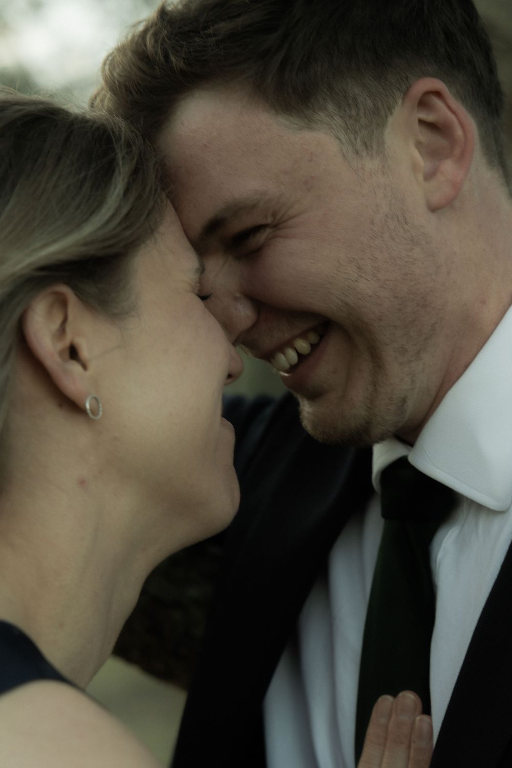 Intimate close-up moment between couple in formal wear.