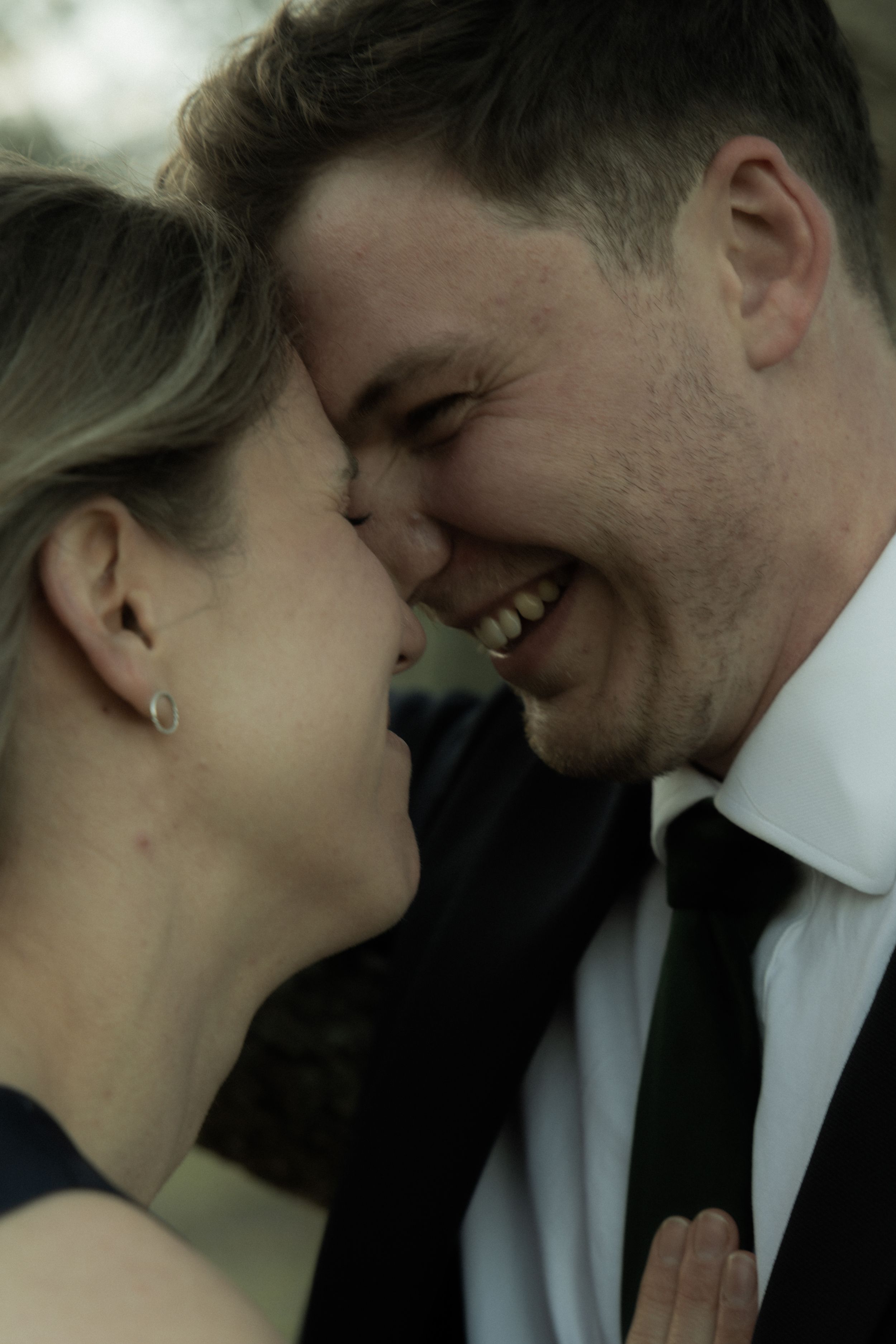 Intimate close-up moment between couple in formal wear.
