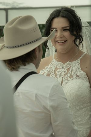 Intimate wedding portrait with one wearing a white lace dress and veil.