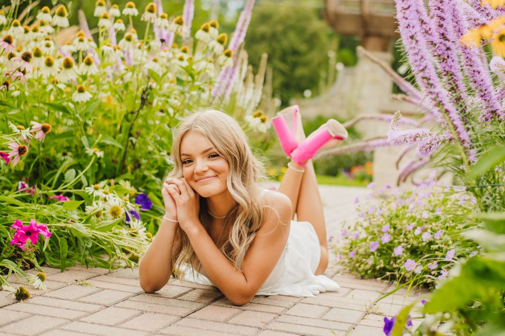 Summer portrait session among purple lavender and colorful garden flowers.