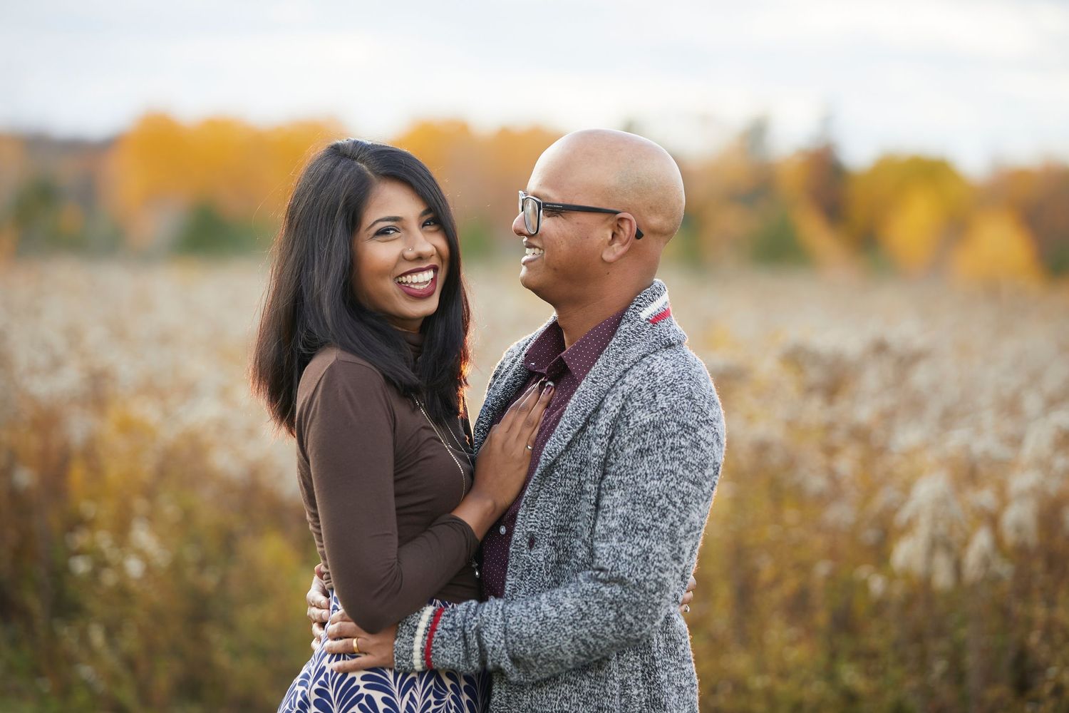 Outdoor portrait session in tall grass during golden hour.