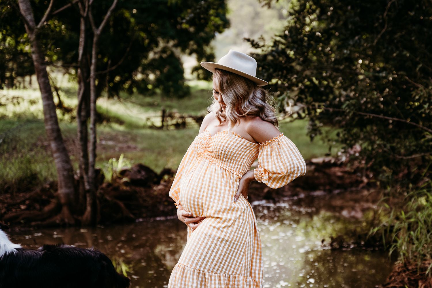 A peachy dress with balloon sleeves creates a beautiful silhouette in a wooded setting.