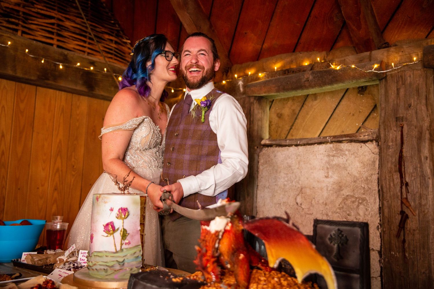 Rustic barn wedding celebration with string lights and festive decorations.