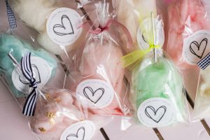 Assorted cotton candy in clear bags with heart stickers arranged in a display.