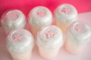 Row of cotton candy servings decorated with star shapes and sprinkles.