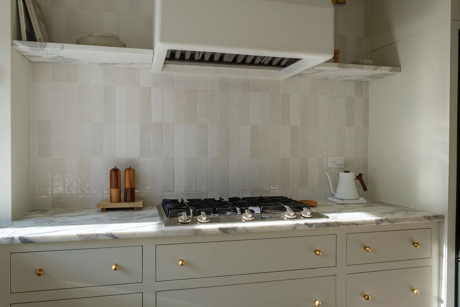 Modern white kitchen interior with sleek cabinetry and minimalist design.